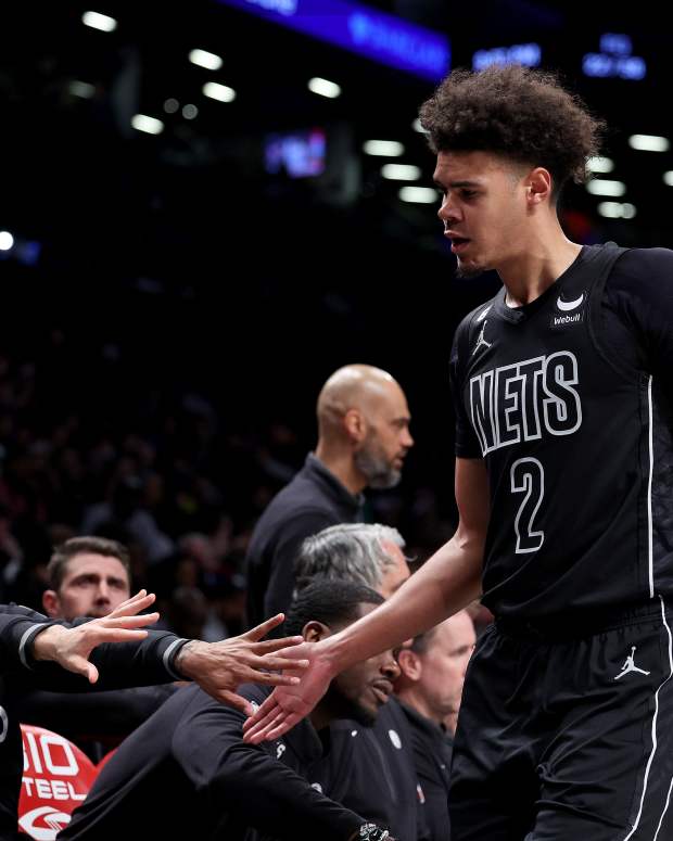 Cameron Johnson high-fiving Brooklyn Nets teammates