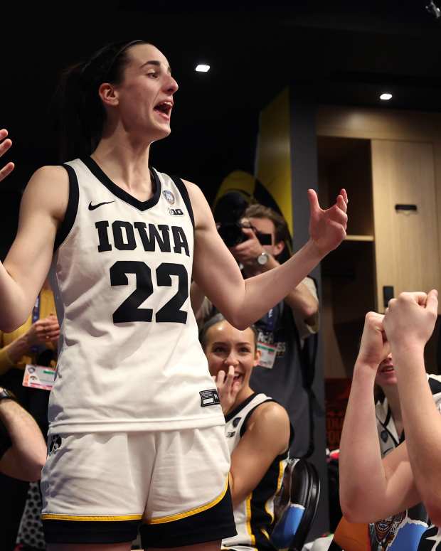 CLEVELAND, OHIO - APRIL 05: Caitlin Clark #22  and Kate Martin #20 of the Iowa Hawkeyes celebrate with the team after beating the UConn Huskies in the NCAA Women's Basketball Tournament Final Four semifinal game at Rocket Mortgage Fieldhouse on April 05, 2024 in Cleveland, Ohio. Iowa defeated Connecticut 71-69. (Photo by Steph Chambers/Getty Images)