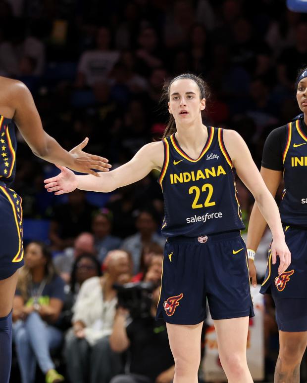 ARLINGTON, TEXAS - MAY 03: Caitlin Clark #22 of the Indiana Fever high-fives Aliyah Boston #7 after a basket against the Dallas Wings during the second quarter in the preseason game at College Park Center on May 03, 2024 in Arlington, Texas.  (Photo by Gregory Shamus/Getty Images)