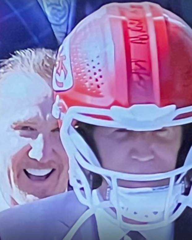 Joe Biden wearing a Kansas City Chiefs helmet.
