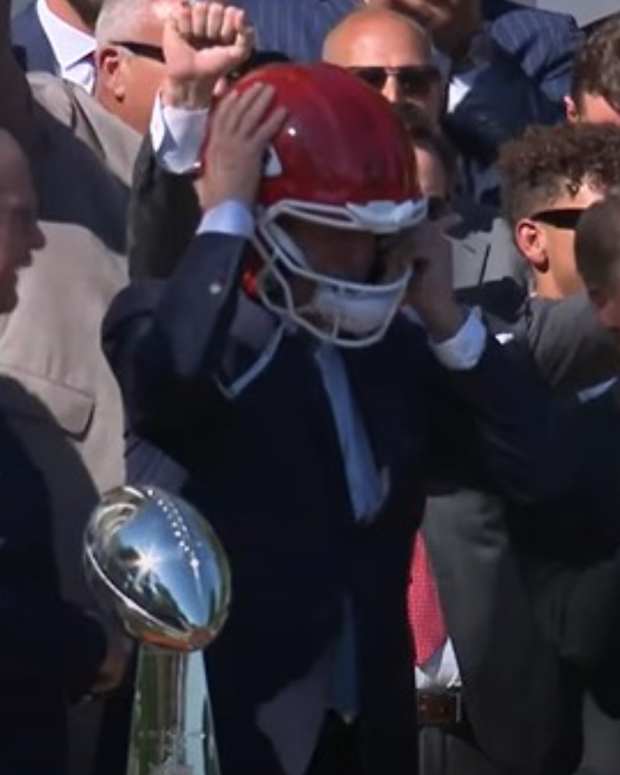 Joe Biden wears a Chiefs helmet.