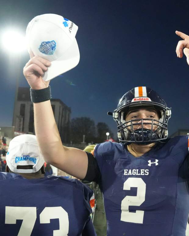 QB Jared Curtis celebrates on the sideline.