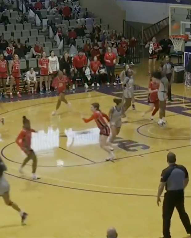 College basketball player scores in her own basket.