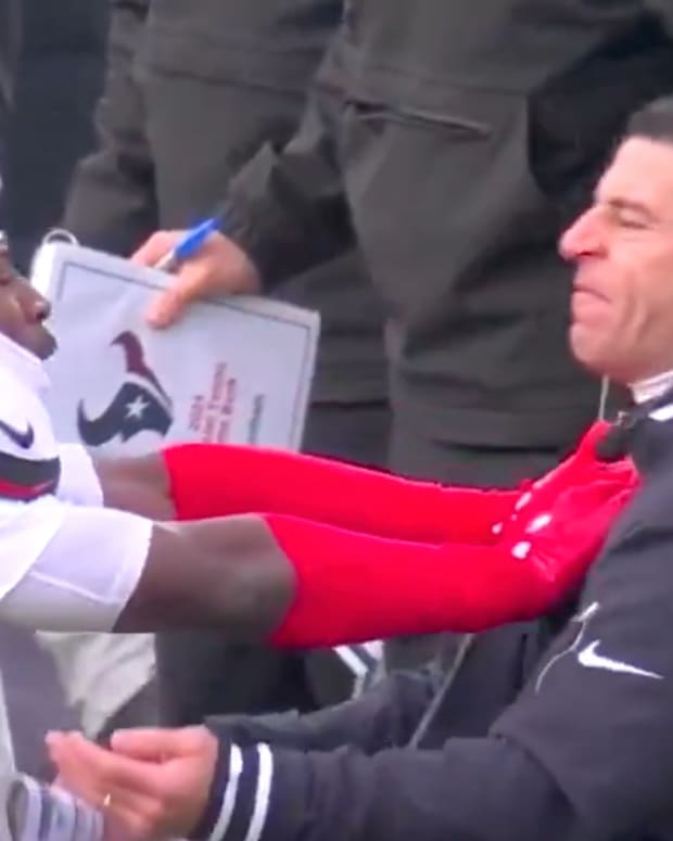 Texans cornerback Kris Boyd shoves Houston special teams coach Frank Ross in the playoffs.