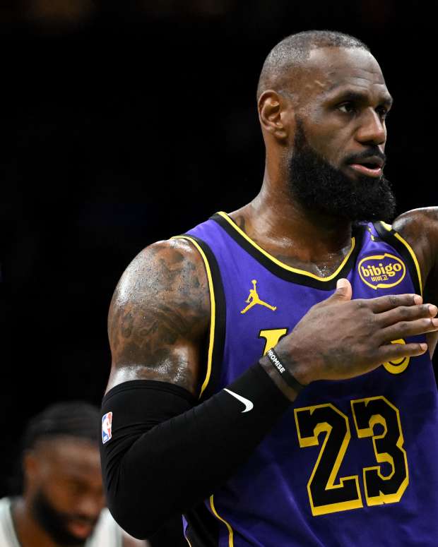 Mar 8, 2025; Boston, Massachusetts, USA; Los Angeles Lakers forward LeBron James (23) controls the ball against Boston Celtics center Al Horford (42) during the third quarter at the TD Garden.