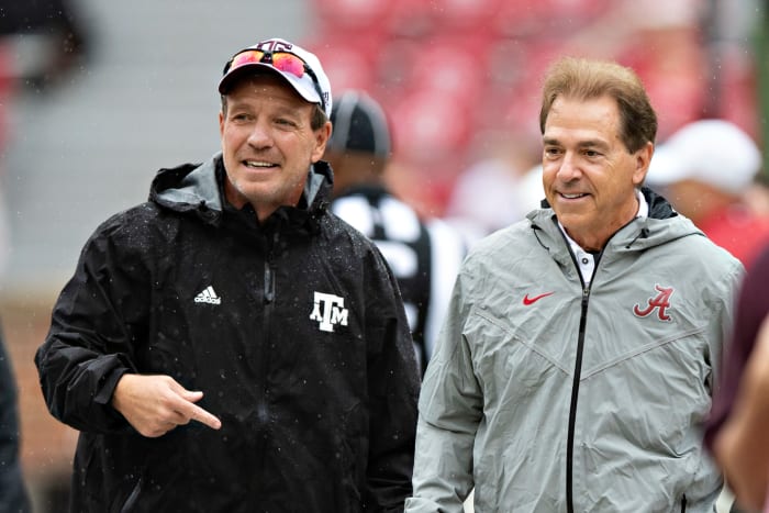 Jimbo Fisher walks with Nick Saban at midfield.