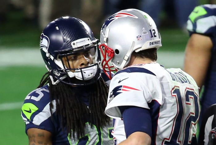 Richard Sherman speaks with Tom Brady at the end of Super Bowl XLIX.