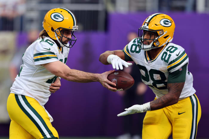 Aaron Rodgers hands off the ball to AJ Dillon.