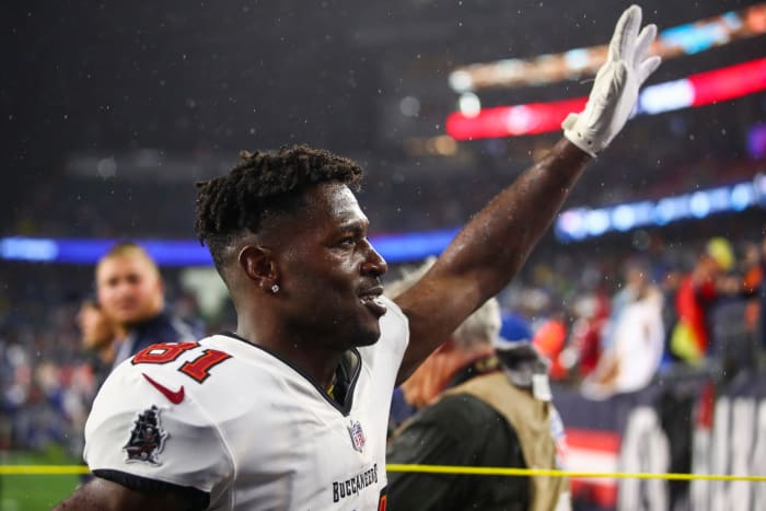 Bucs receiver Antonio Brown waves to the crowd in New England.