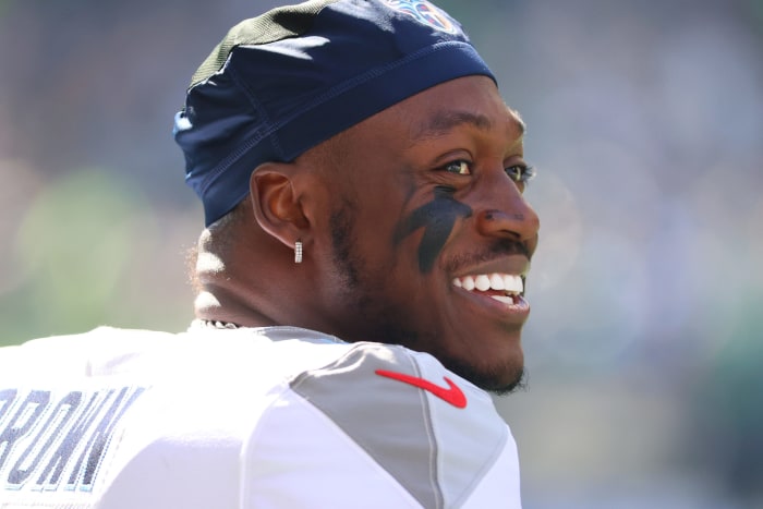 Titans wide receiver A.J. Brown looks into the distance smiling.