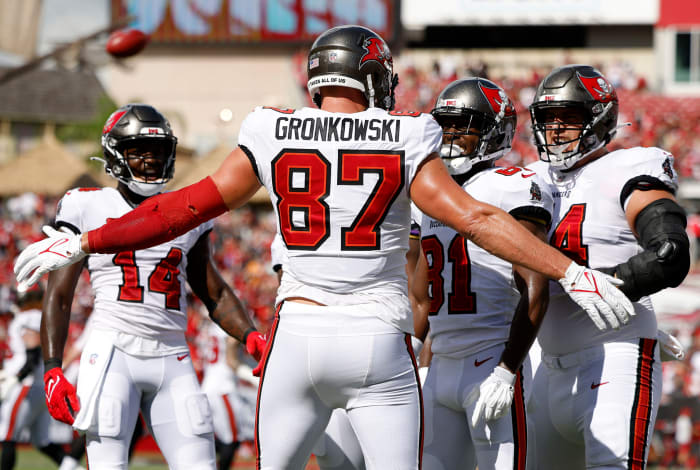 Rob Gronkowski embraces his Buccaneers teammates after scoring a touchdown.