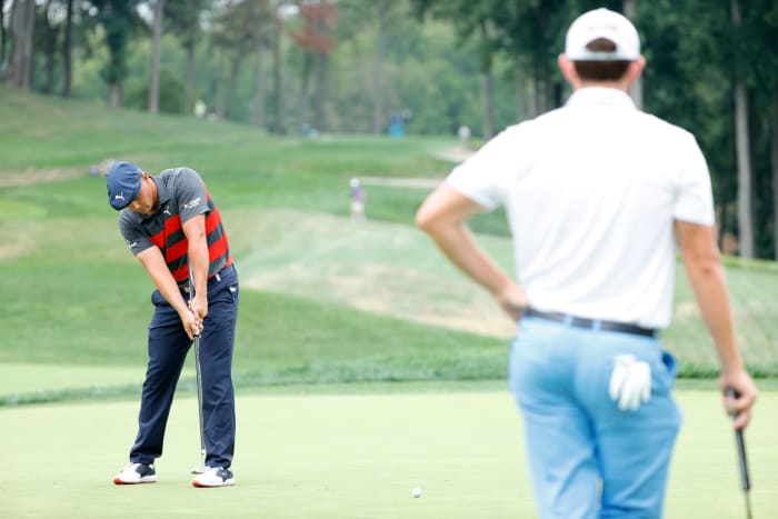 Bryson DeChambeau putts with Patrick Cantlay on Sunday afternoon.