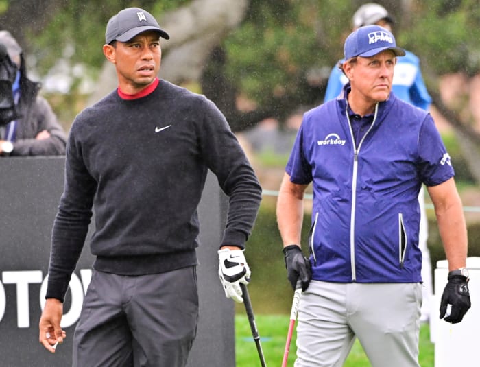 Tiger Woods and Phil Mickelson on the course.