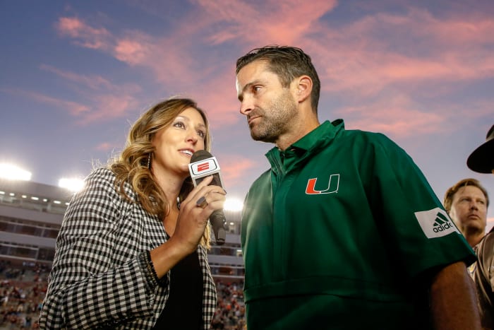 ESPN sideline reporter Allison Williams interviews Miami head coach Manny Diaz.