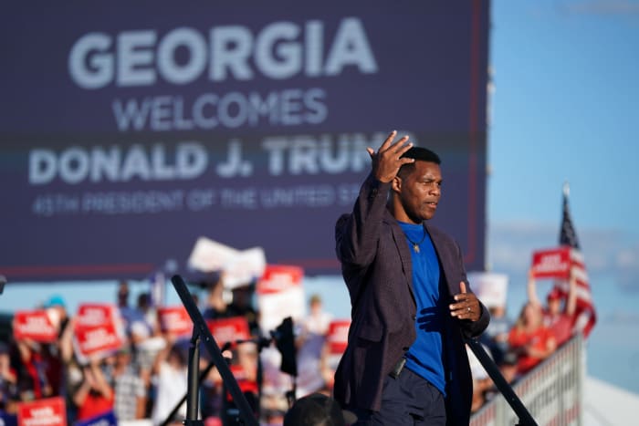 Herschel Walker attends a Donald Trump rally.