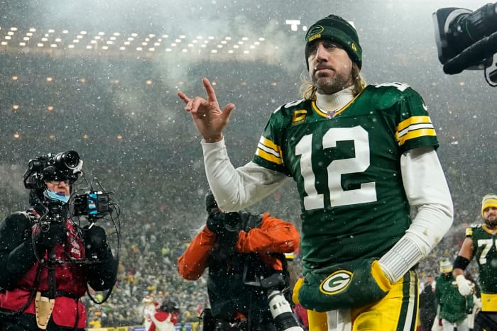 Aaron Rodgers walks off the field on Saturday night.