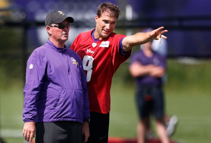 Minnesota Vikings head coach Mike Zimmer left and quarterback Kirk Cousins (8) went over a play during Minnesota Vikings training camp at TCO Performance center Saturday July 28, 2018 in Eagan, MN.