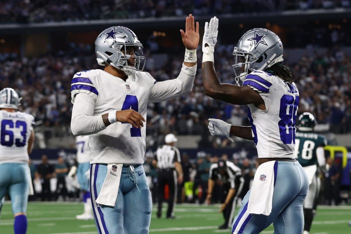 Dak Prescott and CeeDee Lamb high-five after a touchdown.