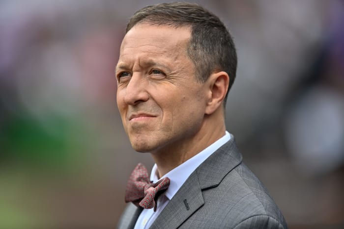 FOX Sports reporter Ken Rosenthal looks on.