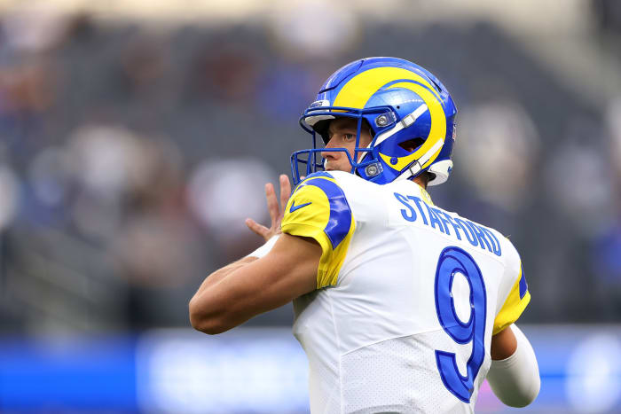 Matthew Stafford warms up on the field.