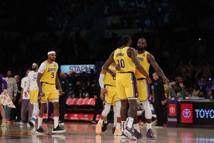 DeAndre Jordan and LeBron James embrace.