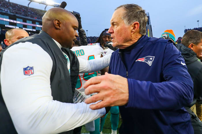 Brian Flores and Bill Belichick on the field.