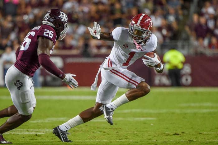 Jameson Williams runs with the football.