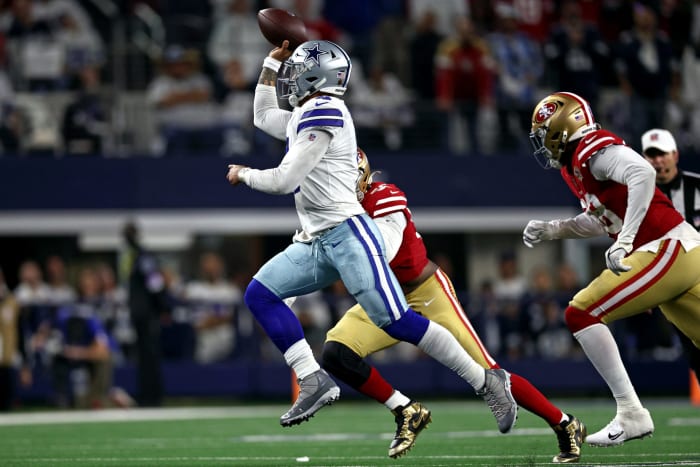 Dak Prescott runs with the football against the 49ers.