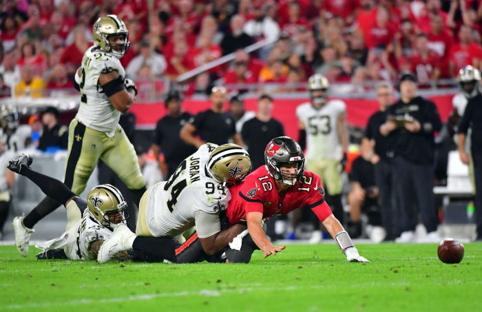 Tom Brady gets hit by Cam Jordan.