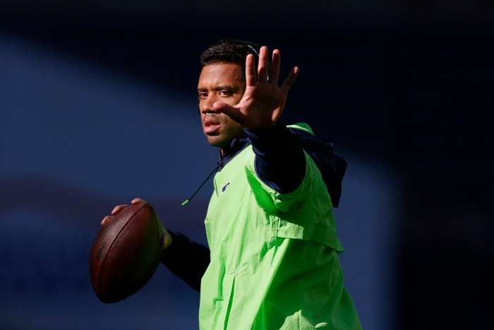 Russell Wilson warms up on the field.