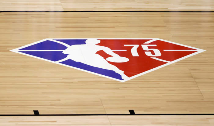 The NBA 75 logo is displayed on a basketball court.