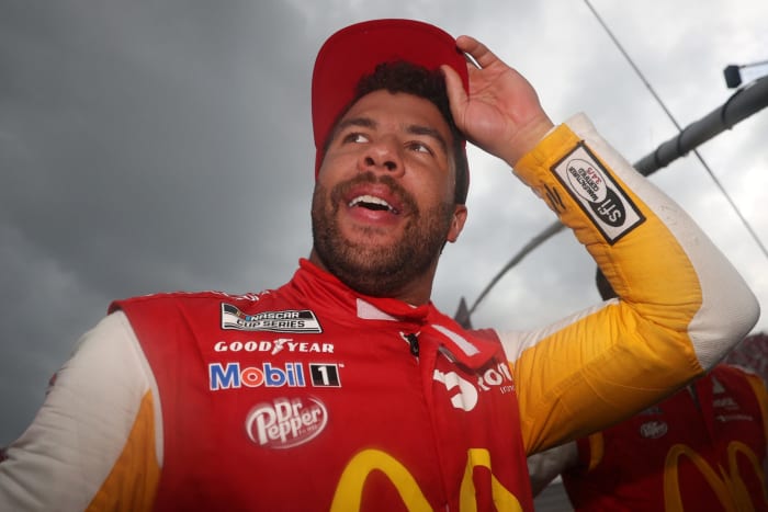 Bubba Wallace stares off into the distance while celebrating his victory in the Yellawood 500.