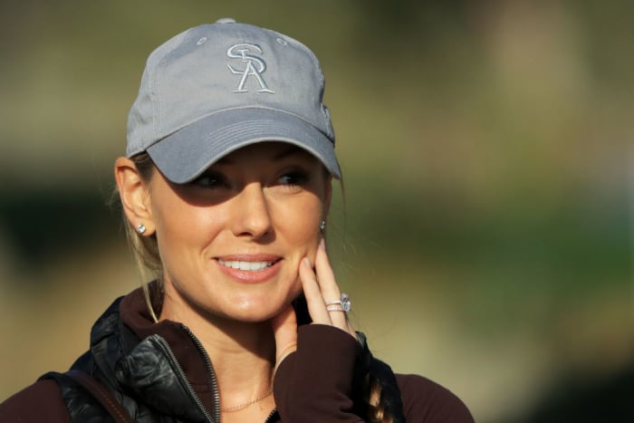 A photo of Rory McIlroy's wife smiling.