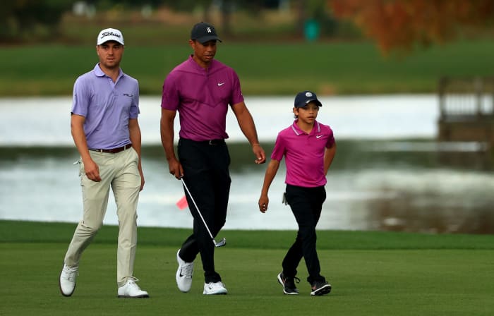 Justin Thomas and Tiger Woods on the course with Woods' son, Charlie.