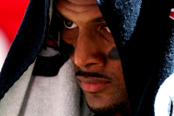 Houston Texans quarterback Deshaun Watson on the field wearing a towel.