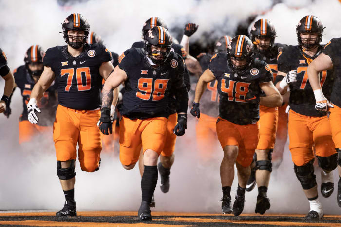 Oklahoma State players run out onto the field.