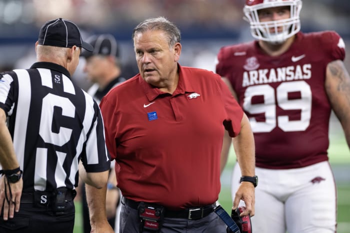 Arkansas head coach Sam Pittman talks to a referee.