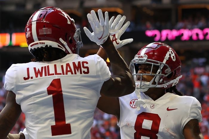 Alabama wide receiver Jameson Williams celebrates with John Metchie III.