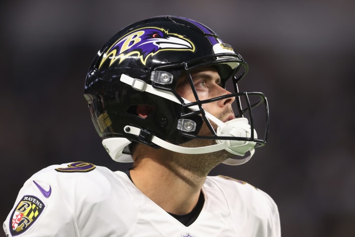 Ravens kicker Justin Tucker looks on from the sidelines.