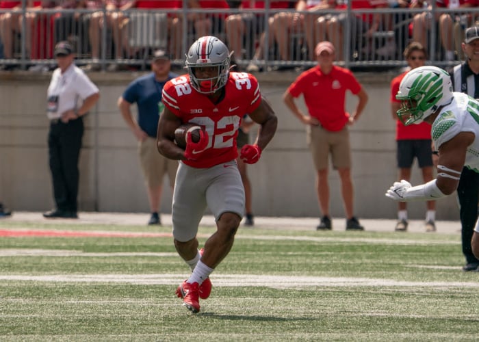 Ohio State running back TreVeyon Henderson runs the ball.