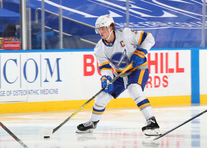 Jack Eichel skates up the ice with the puck.