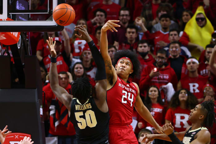 Rutgers' Ron Harper Jr. and Purdue's Trevion Williams battle for the ball.