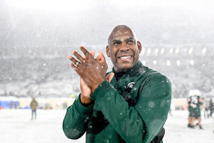 Michigan State head coach Mel Tucker smiles after a win in the snow.