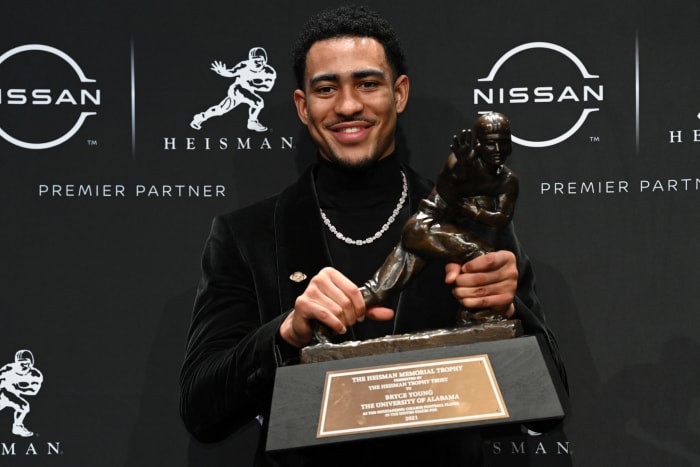 Alabama's Bryce Young holds up the Heisman Trophy.