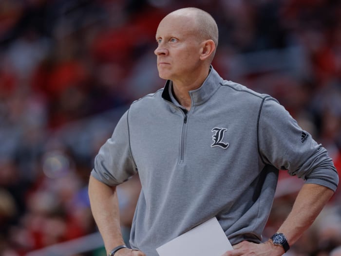 Louisville men's basketball head coach Chris Mack looks on with a frown.