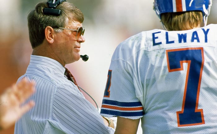 Dan Reeves stands with John Elway.