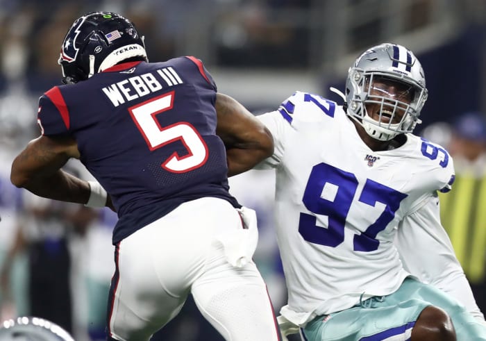 Taco Charlton makes a tackle while playing for the Dallas Cowboys.
