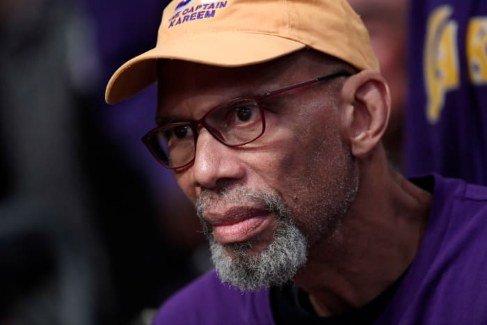 Former Lakers great Kareem Abdul-Jabbar looks on.