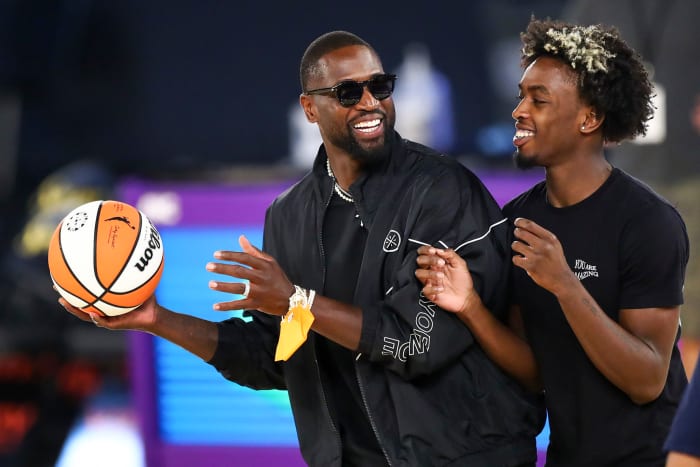 Dwyane Wade and his son, Zaire spend time on the court after a WNBA game.