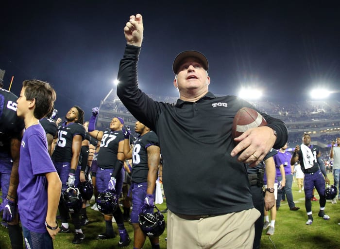 Head coach Gary Patterson of the TCU Horned Frogs holds his arm up as the band plays the alma mater after the 24-7 win over the Texas Longhorns.
